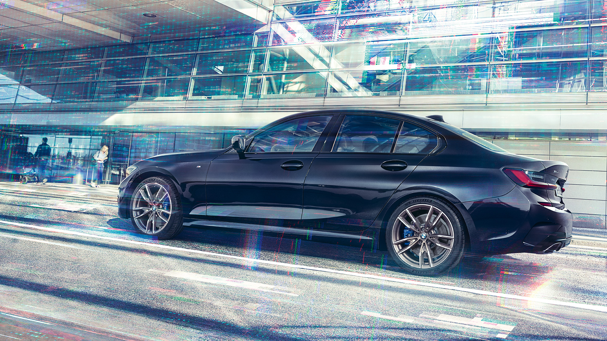 Visão lateral do BMW M340i xDrive Sedan BMW M340i xDrive Sedan G20 em preto safira metálico, visão lateral durante a condução do veículo