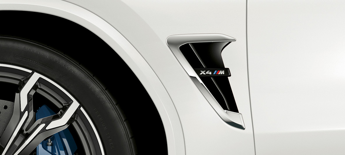 BMW X4 M, respiro M. BMW X4 M em Branco Alpino, exterior, respiro M com detalhes cromados e designação do modelo.