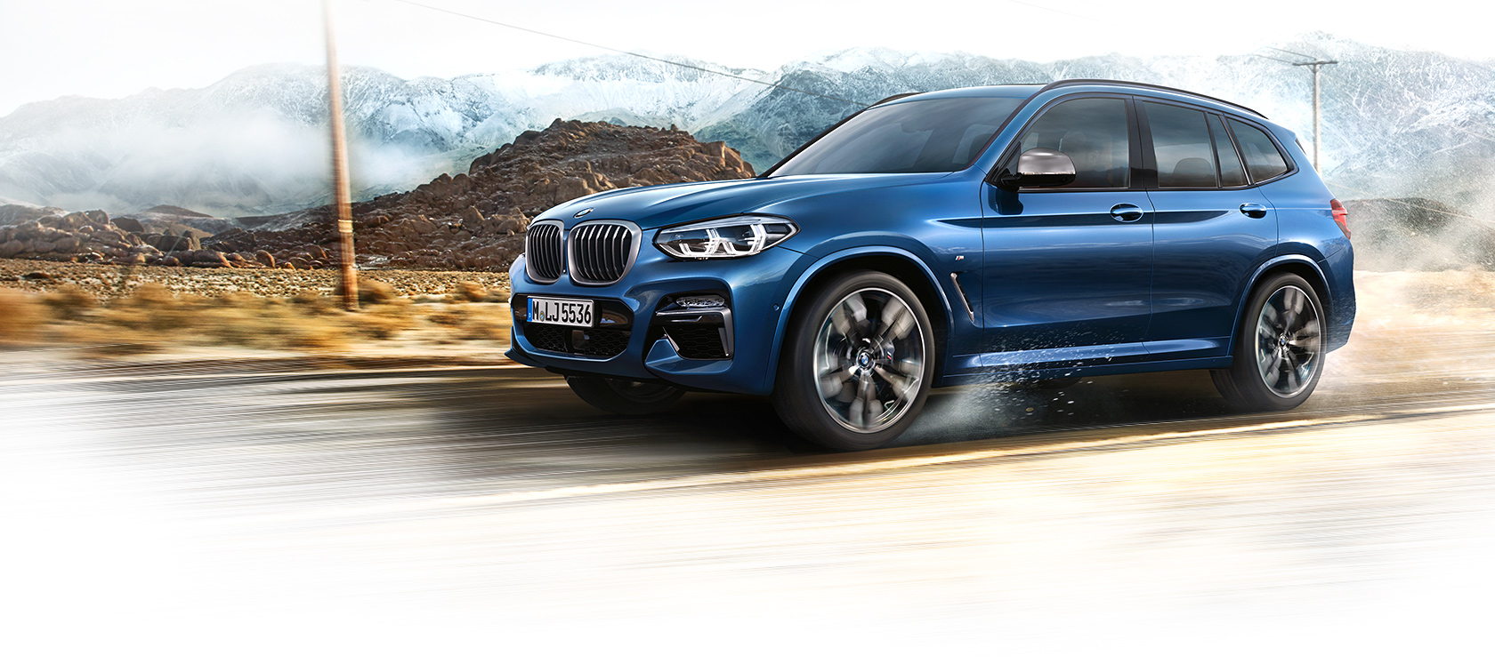 BMW X3 2020 Azul trafegando em velocidade em meio a montanhas, visão lateral BMW X3 2020 Azul trafegando em velocidade em meio a montanhas, visão lateral