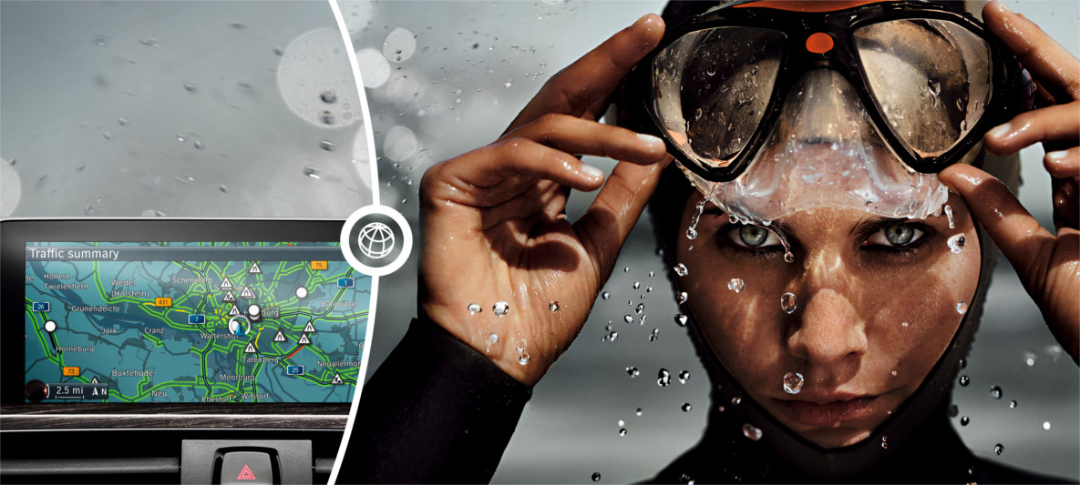 Mapa de navegação na tela do BMW junto a imagem de mulher emergindo da água com equipamentos de mergulho Mapa de navegação na tela do BMW junto a imagem de mulher emergindo da água com equipamentos de mergulho