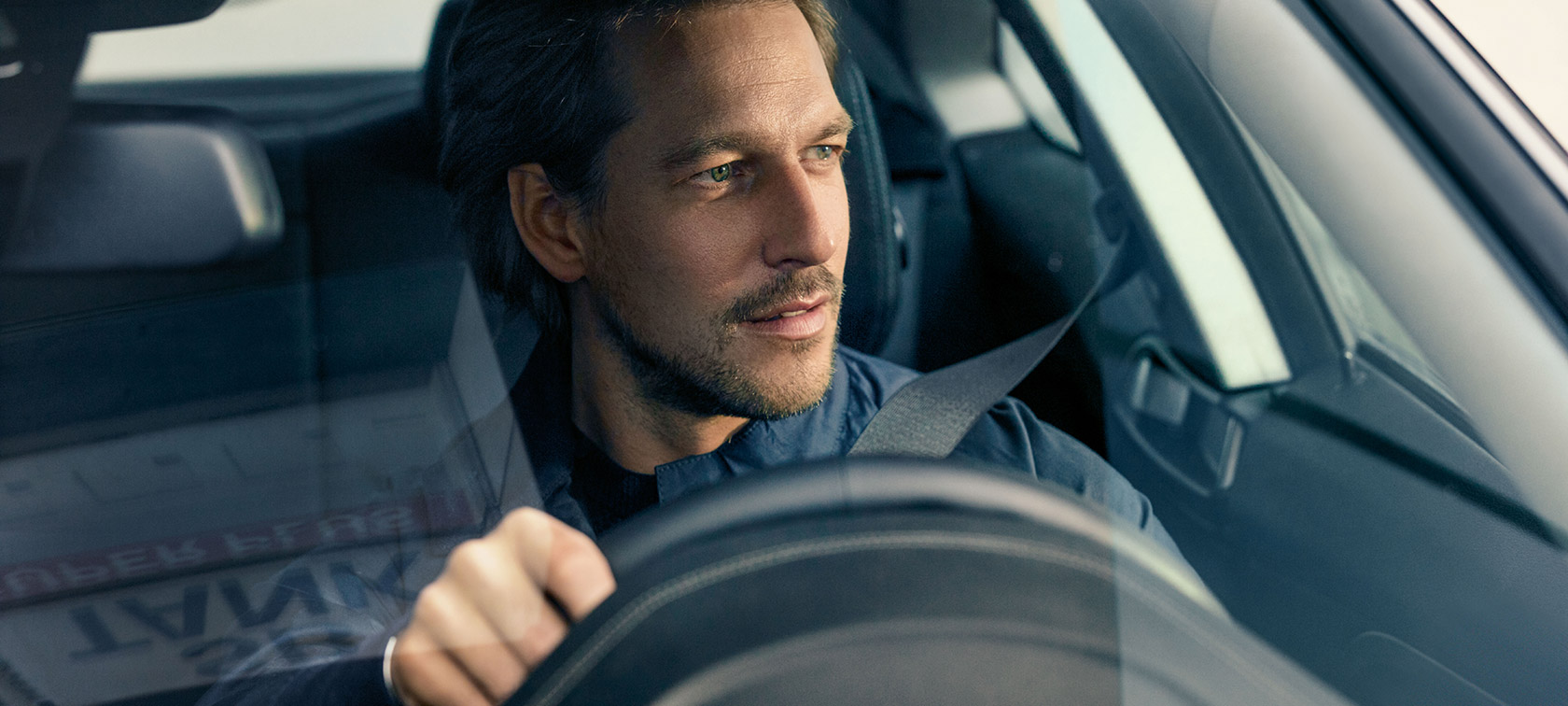 A man sensitively touching his BMW. A man sensitively touching his BMW.